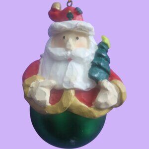 Round ball ornament bottom Santa with tree on hat and in hand in green and white